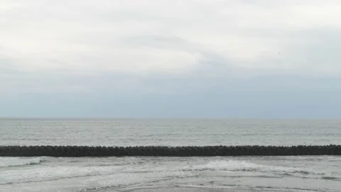 Dramatic clouds over tetrapods in the sea in Kawazu, Shizuoka Prefecture, Japan Stock Footage 194407793