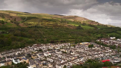 Dramatic clouds passing over a welsh valley town Stock Footage 336757331