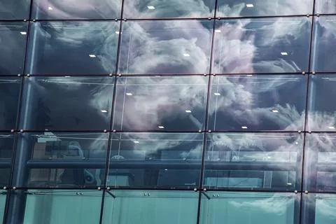 Dramatic Clouds Reflected in a Gridded Glass Facade Stock Photos