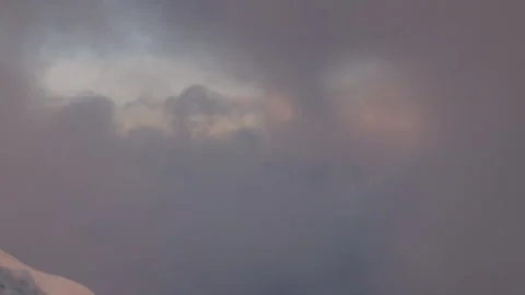 Dramatic clouds revealing a snowy mountain range Stock Footage 335100844