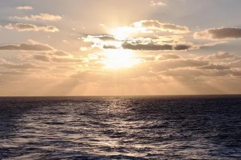 Dramatic clouds sea sunset with sunrays Stock Photos