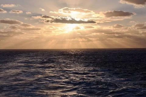 Dramatic clouds sea sunset with sunrays Stock Photos