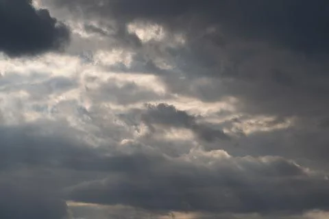 Dramatic clouds split with sun beams, bold contrast and shadowed banks prod.. Stockfoto's