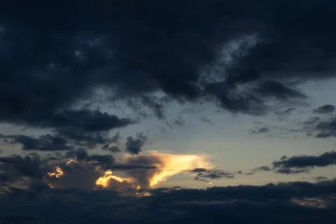 Dramatic Clouds at Sunset with Golden Light 스톡 사진