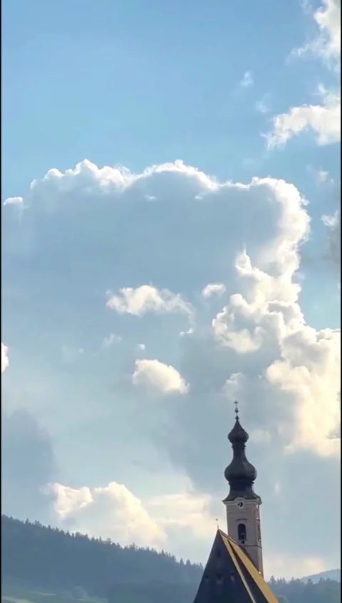 Dramatic clouds time lapse over church tower in alpine village Stock Footage 346091951