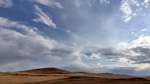 Dramatic clouds timelapse moving over desert hills. Stock Footage 328336964