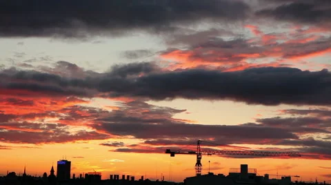 Dramatic clouds timelapse at sunset over a city skyline silhouette Stock Footage 41337858