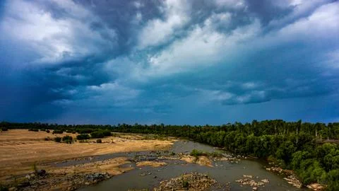 A Dramatic Cloudscape Above a Serene and Tranquil River Landscape that Capt.. Stock Photos