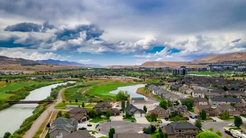 Dramatic cloudscape above a suburban area and golf course - aerial hyper Vídeos de archivo 135849044