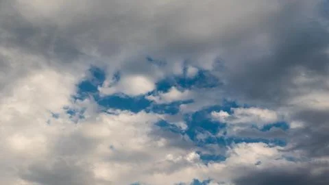 Dramatic cloudscape with blue sky peeking through stormy clouds 写真素材