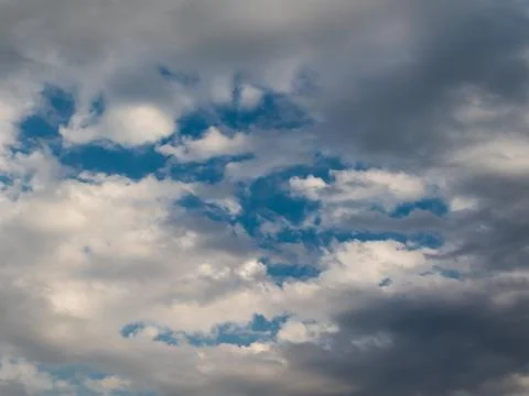 Dramatic cloudscape with blue sky peeking through stormy clouds Stock Photos