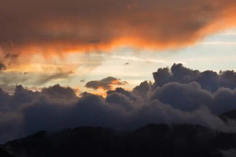 Dramatic cloudscape clouds sunset over mountains Stock Photos