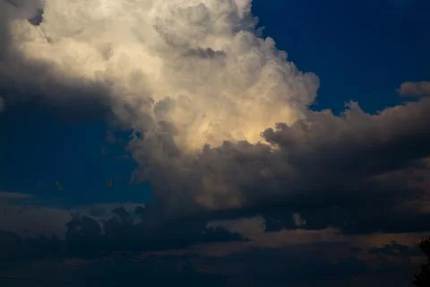 Dramatic cloudscape with contrasting light and shadows. Stock Photos