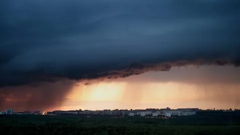 The dramatic cloudscape during the evening sky foretells rain and a lightning Stock Photos