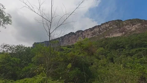 Dramatic Cloudscape over Lush Green Mountain Range with Trees Stock Footage 332727175
