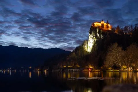 Dramatic cloudscape over medieval castle of Bled perched on cliff above Bled Stock Photos