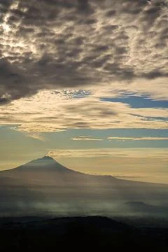 Dramatic cloudscape over a volcano and misty valley in Java, Indonesia Photos