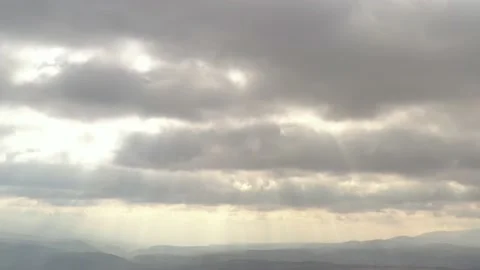 Dramatic cloudscape with rays of sun 4K aerial footage Stock Footage 105296231