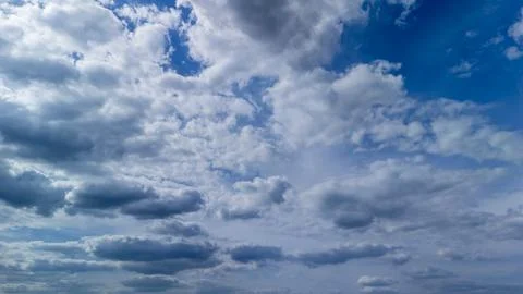 Dramatic cloudscape showcasing a variety of cloud types in a deep blue sky. Stock Photos