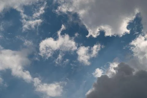 Dramatic cloudscape with sunlit cumulus and blue sky Stock Photos