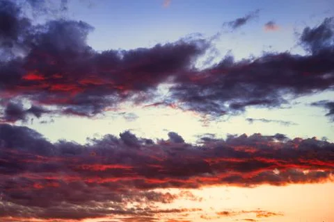 Dramatic cloudscape at sunset. Colorful dramatic sky. Stock Photos