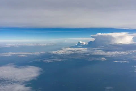 Dramatic cloudscape viewed from passenger airplane during summer flight Stock Photos