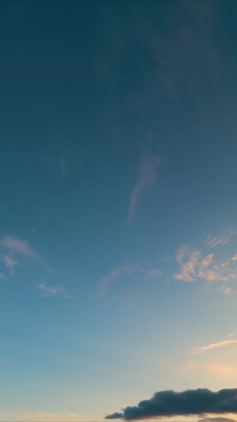 Dramatic cloudscape with warm glow, Serene sunset with colorful sky and drifting Stock Footage 325670004