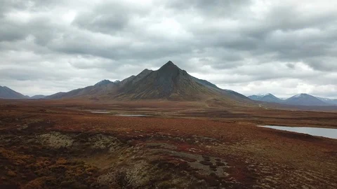 A dramatic cloudy Fall (Autumn) day in an arctic tundra landscape Stock Footage 127380932