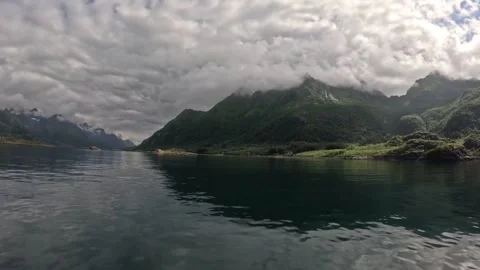 Dramatic cloudy mountains reflecting in calm fjord water in Lofoten Stock-Footage 344453294