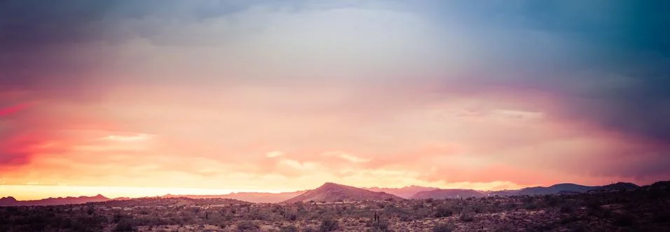 A dramatic cloudy panorama sunset in the desert of Arizona Stock Photos