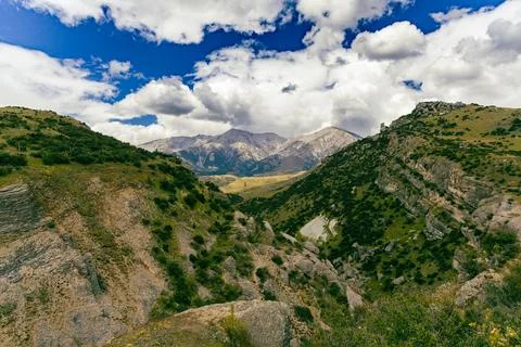 Dramatic Cloudy Sky Above Rocky Mountain Valley Stock Photos