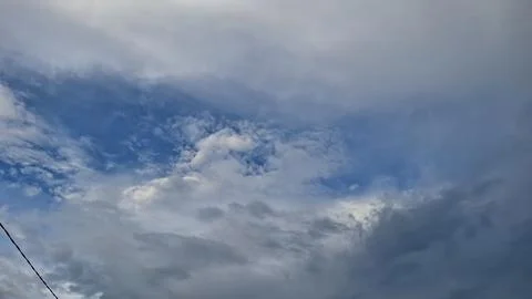Dramatic Cloudy Sky with Blue Sky Patches Stock Photos