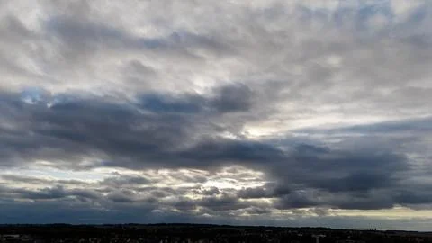Dramatic cloudy sky with dark clouds over scenic horizon at dusk Stock Photos