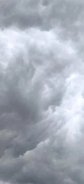 Dramatic cloudy sky with dark storm clouds and sunlight rays 写真素材