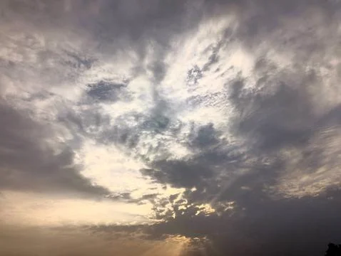 Dramatic cloudy sky with golden sun rays Stock Photos