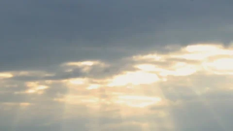 Dramatic cloudy sky with golden sunlight breaking through moving clouds Stock Footage 310178820