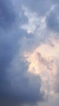 Dramatic cloudy sky with hidden sunlight. The beauty of natural phenomena Stock Photos