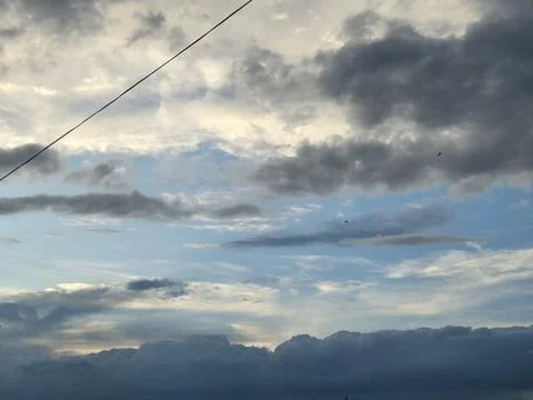 Dramatic Cloudy Sky With Mountains and Power Line Stock Photos