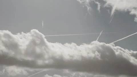 Dramatic cloudy sky with multiple aircraft contrails crossing. 4K 60fps. Stock Footage 334040040