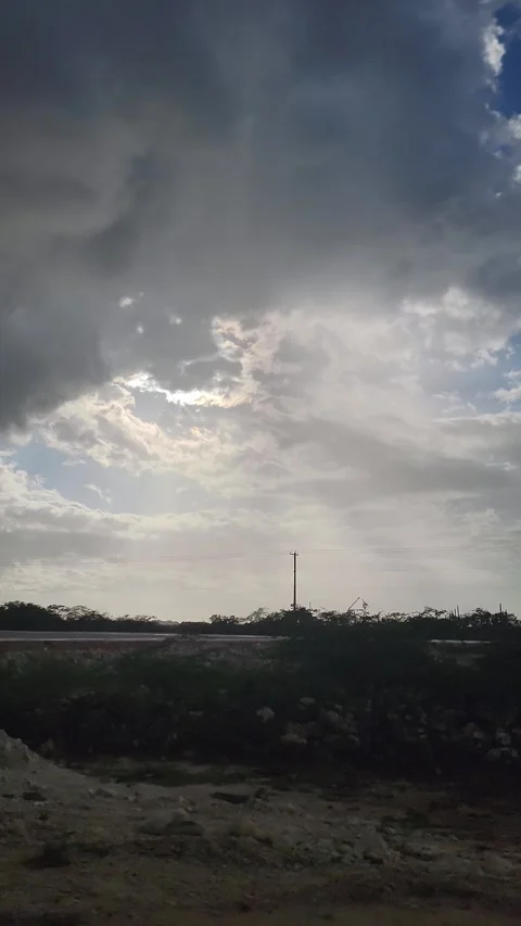 Dramatic cloudy sky over asphalt road with sun breaking through clouds 4K Vidéo 329073161