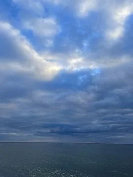 Dramatic Cloudy Sky Over Calm Sea Stock Photos