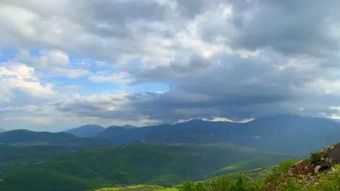 Dramatic cloudy sky over distant mountain range with soft light Stock Footage 310247021