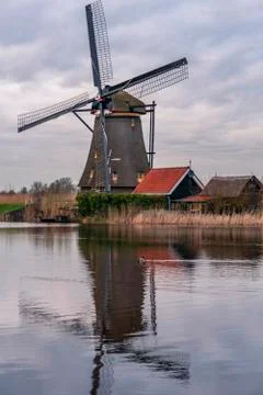 Dramatic cloudy sky over the famous Windmills in Kinderdijk Holland. Sunny Stock Photos