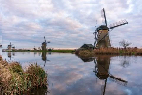 Dramatic cloudy sky over the famous Windmills in Kinderdijk Holland. Sunny Stock Photos