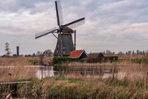 Dramatic cloudy sky over the famous Windmills in Kinderdijk Holland. Sunny Stock Photos