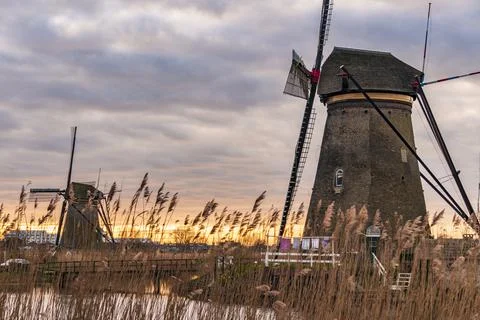 Dramatic cloudy sky over the famous Windmills in Kinderdijk Holland. Sunny Stock Photos