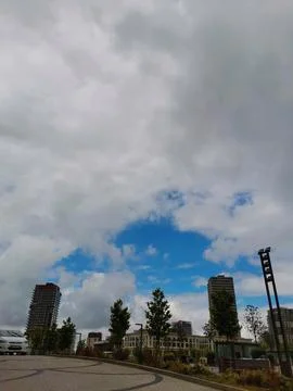 Dramatic cloudy sky over modern city skyline. Stock Photos
