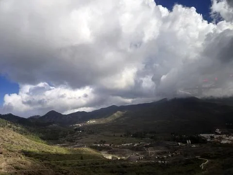 Dramatic cloudy sky over mountain valley landscape Stock Photos