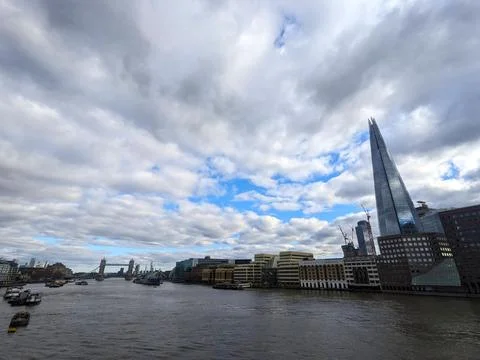 Dramatic cloudy sky over the River Thames with The Shard skyscraper and Tower Stock Photos