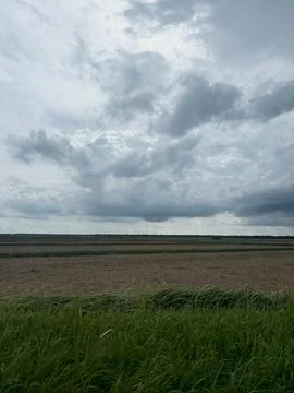 Dramatic Cloudy Sky over Rural Paddy Fields in Malaysia Stock Photos
